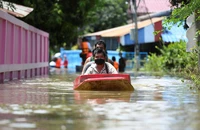 Người dân đi thuyền qua một con đường bị ngập nặng ở tỉnh Lopburi, Thái Lan. (Ảnh: Reuters)