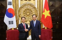 Bộ trưởng Đào Ngọc Dung và Bộ trưởng Việc làm và Lao động Hàn Quốc Lee Jung Sik. (Ảnh: Molisa)
