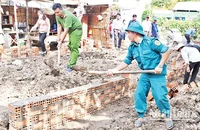 Lực lượng vũ trang cùng các đoàn thể chính trị xã Huyền Hội, huyện Càng Long, tỉnh Trà Vinh, hỗ trợ người dân xây nhà. (Ảnh: KHỞI - GIANG)