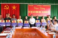 Tổng Biên tập Báo Nhân Dân Lê Quốc Minh trao tặng quà cho gia đình khó khăn, dân tộc Khmer tại xã Trà Côn, huyện Trà Ôn, tỉnh Vĩnh Long. 
