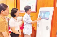 Cán bộ, nhân viên Bảo tàng tỉnh Nam Ðịnh trao đổi kinh nghiệm vận hành máy tra cứu thông tin hiện vật 3D.