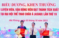 Lãnh đạo Ủy ban nhân dân thành phố Hải Phòng trao Bằng khen và tiền thưởng tặng vận động viên Phạm Quang Huy (trái) và huấn luyện viên Phạm Cao Sơn (phải).