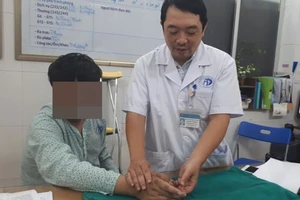 BS Nguyễn Vũ Hoàng – Phó trưởng Khoa phẫu thuật tạo hình (Bệnh viện Xanh Pôn) đang kiểm tra lại tay cho bệnh nhân trước khi xuất viện.