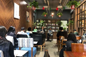 Tác giả Trần Quang Đức (ngồi giữa) chia sẻ với độc giả trong buổi giao lưu ra mắt sách.