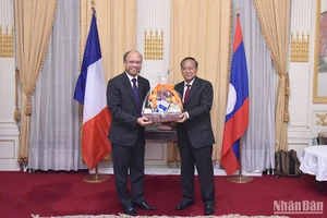 Đại sứ Đinh Toàn Thắng tặng quà và chúc mừng Đại sứ Kham-Inh Khitchadeth nhân dịp Quốc khánh. (Ảnh: Khải Hoàn)