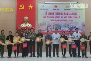 Các đồng chí lãnh đạo Bộ Công an và tỉnh Hà Tĩnh trao quà và chìa khóa tượng trưng cho các hộ dân.