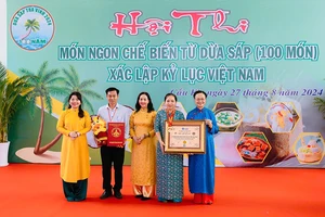 Đại diện lãnh đạo Ủy ban nhân dân huyện Cầu Kè nhận Bằng xác lập kỷ lục Việt Nam.