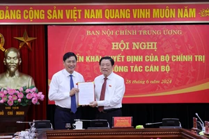 Đồng chí Phan Đình Trạc trao Quyết định của Bộ Chính trị cho đồng chí Nguyễn Hữu Đông.