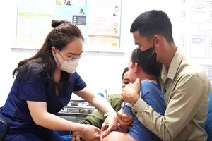 Nhân viên Trung tâm Kiểm soát bệnh tật Quảng Bình tiêm vaccine phòng dại cho trẻ em. (Ảnh: NH)