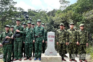 Cán bộ, chiến sĩ Đồn Biên phòng cửa khẩu quốc tế Cha Lo (Bộ đội Biên phòng Quảng Bình) và Đại đội Biên phòng 311 và 312 (Bộ Chỉ huy Quân sự tỉnh Khammouane) chụp ảnh lưu niệm bên mốc giới số 522.