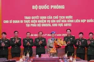 Thượng tướng Phùng Sĩ Tấn cùng đại diện các cơ quan, đơn vị chúc mừng Thiếu tá Hoàng Đình Công chuẩn bị lên đường làm nhiệm vụ giữ gìn hòa bình Liên hợp quốc. 