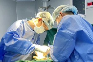Thạc sĩ, bác sĩ Huỳnh Bá Tấn và ê-kíp phẫu thuật cho người bệnh.