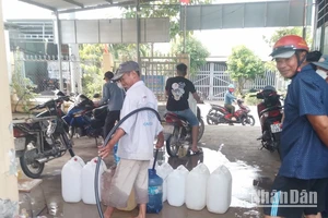 Người dân xã Tân Tập (Cần Giuộc, Long An) lấy nước ngọt từ xe chờ nước của đơn vị cấp nước hỗ trợ bà con trong lúc thiếu nguồn nước ngọt hợp vệ sinh từ hệ thống cấp nước. 