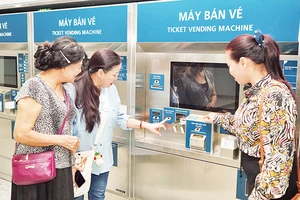 Người dân trải nghiệm tại máy bán vé tự động bên trong ga ngầm Bến Thành, thuộc tuyến Metro số 1. (Ảnh THẾ ANH)