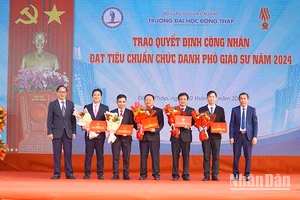 Phó Giáo sư, Tiến sĩ Nguyễn Văn Đệ, Chủ tịch Hội đồng Khoa học và Đào tạo, Phó Chủ tịch Hội đồng chức danh giáo sư cơ sở Trường đại học Đồng Tháp thừa ủy quyền của Chủ tịch Hội đồng giáo sư nhà nước trao Quyết định công nhận đạt tiêu chuẩn chức danh phó giáo sư năm 2024 cho 5 nhà giáo. (Ảnh: HỮU NGHĨA)