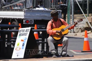 Một người dân Nam Phi chơi đàn trên phố ở thành phố Cape Town. (Ảnh: TTXVN)