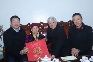 Đồng chí Đỗ Văn Chiến tặng quà Tết cho bà Nguyễn Thị Khiêm, thị trấn Bằng Lũng, huyện Chợ Đồn. (Ảnh: VŨ GIANG)