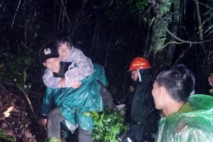 Lực lượng cứu hộ đưa các du khách bị lạc giữa rừng xuống núi sau khi tìm thấy.