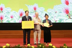 Ông Nguyễn Tất Thắng, Chủ tịch Hội đồng quản trị Tập đoàn T&T Group (giữa) trao tặng tỉnh Điện Biên 5 tỷ đồng (100 căn nhà) và trao chìa khoá tượng trưng cho gia đình được hỗ trợ làm nhà.