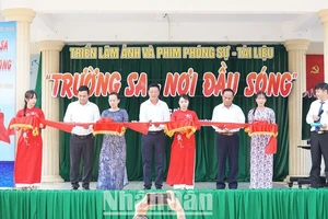 Nhà báo Nguyễn Quốc Hưng và lãnh đạo huyện Ea Súp cắt băng khai mạc triển lãm.