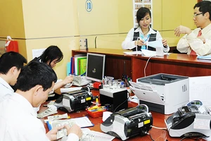 Tỷ giá chịu tác động mạnh mẽ do nhu cầu nhập khẩu hàng hóa của các doanh nghiệp. Ảnh: NAM HẢI