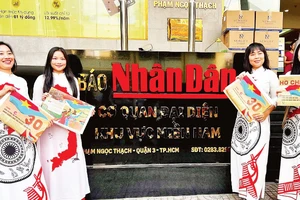 Độc giả đón nhận phụ san đặc biệt tuyên truyền Lễ kỷ niệm 50 năm Ngày Giải phóng miền nam, thống nhất đất nước của Báo Nhân Dân.