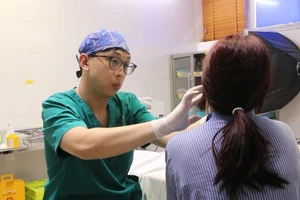 Bác sĩ khám, đánh giá biến chứng trên má cho người bệnh.