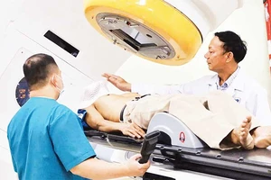 Bác sĩ kiểm tra bệnh nhân trước khi xạ trị lần đầu.