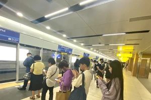 Hành khách xếp hàng chờ tàu Metro số 1 ở nhà ga. (Ảnh: QUÝ HIỀN)