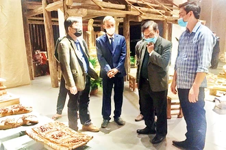 Nghệ nhân Nguyễn Văn Quyết (thứ hai từ trái sang) trao đổi với các nhà nghiên cứu về điêu khắc Việt Nam truyền thống. 