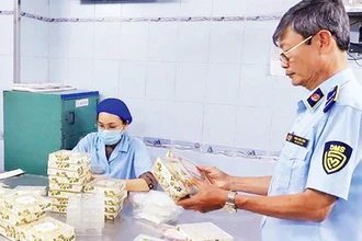 Các đơn vị chức năng thuộc Cục Quản lý thị trường thành phố kiểm tra một cơ sở sản xuất hàng hóa tại quận Phú Nhuận.