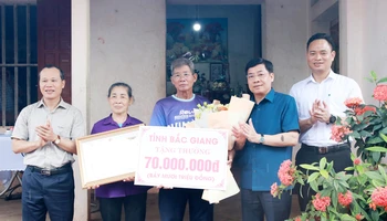 Bí thư Tỉnh ủy Bắc Giang Dương Văn Thái (thứ 2, phải sang) tặng quà cho đại diện gia đình vận động viên Nguyễn Thị Oanh.