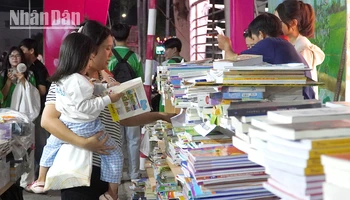 Một cháu bé đi cùng mẹ tại Ngày sách và văn hóa đọc tỉnh Đồng Tháp. (Ảnh: HỮU NGHĨA)