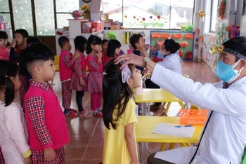 Khám sàng lọc bệnh tay chân miệng cho trẻ tại Trường mầm non Anh Đào, TP Đà Lạt (Ảnh: A.N)