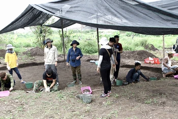 GS Lâm Mỹ Dung ( đứng thứ 3 từ trái sang) và TS Nguyễn ANh Thư (áo đen đứng) tại di chỉ khảo cổ Vườn Chuối.