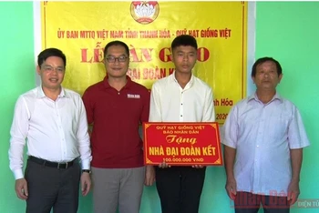 Lãnh đạo MTTQ tỉnh Thanh Hóa, đại diện Báo Nhân Dân trao biểu trưng hỗ trợ xây dựng nhà “Đại đoàn kết” cho cháu Đạt.