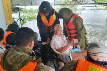 Công an huyện Thạch Hà giúp dân sơ tán trong mưa lũ. (Ảnh: NGÔ TUẤN)
