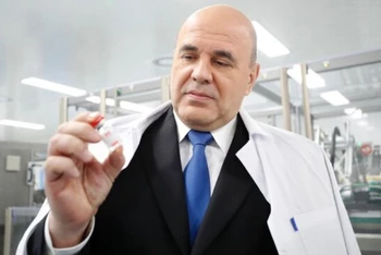 Thủ tướng Nga M. Mushustin thị sát một dây chuyền sản xuất vaccine Sputnik V tại Saint Petersburg. (Ảnh: TASS)