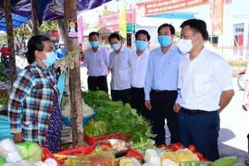 Chủ tịch UBND tỉnh Cà Mau Lê Quân (bìa phải) kiểm tra công tác phòng dịch tại chợ Rạch Gốc, huyện Ngọc Hiển.
