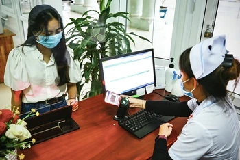 Người dân sử dụng hình ảnh thẻ BHYT trên ứng dụng VssID để đăng ký KCB BHYT tại Bệnh viện đa khoa khu vực miền núi phía bắc Quảng Nam. (Ảnh: Trung Tâm)