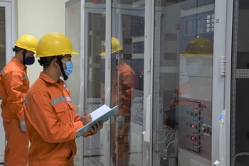 Cán bộ Tổng Công ty Điện lực Hà Nội (EVNHANOI) kiểm tra thiết bị, bảo đảm không để xảy ra sự cố trong thời tiết nắng nóng. Ảnh: DUY LINH