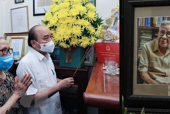 Chủ tịch nước Nguyễn Xuân Phúc đã tới thăm gia đình cố Nhà báo Hữu Thọ. (Ảnh: Thống Nhất/TTXVN)