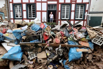 Một người đàn ông nhìn ra ngoài ngôi nhà trong khu vực bị ảnh hưởng bởi lũ lụt do mưa lớn ở Bad Muenstereifel, Đức, ngày 19/7. (Ảnh: Reuters).
