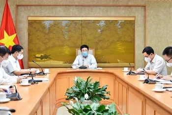 Phó Thủ tướng Phạm Bình Minh đã chủ trì cuộc họp với Tổ công tác của Chính phủ về ngoại giao vaccine. (Ảnh: TTXVN)