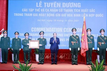 Chủ tịch nước Nguyễn Xuân Phúc trao Huân chương Bảo vệ Tổ quốc hạng Nhì cho Cục Gìn giữ Hòa bình Việt Nam. (Ảnh: TTXVN)