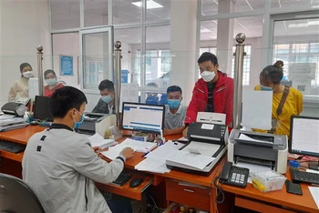 Cán bộ Bảo hiểm xã hội huyện Hòa An, tỉnh Cao Bằng giải quyết chế độ, thủ tục bảo hiểm cho người tham gia.