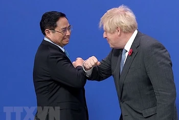 Thủ tướng Anh Boris Johnson đón Thủ tướng Phạm Minh Chính đến dự Hội nghị. (Ảnh: TTXVN)