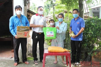 Chị Nguyễn Thị Bích Thu, ở xã Bình Hòa Phước, huyện Long Hồ (tỉnh Vĩnh Long) nhận quà hỗ trợ “Túi an sinh xã hội” của các nhà hảo tâm. 
