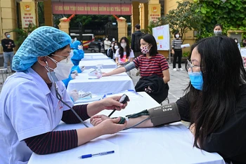Ghi nhận tại điểm tiêm Trường Trung học cơ sở Trưng Vương, hàng trăm học sinh lớp 9 đã có mặt để tiến hành khám sàng lọc, hoàn tất các thủ tục để tiến hành tiêm vaccine.
