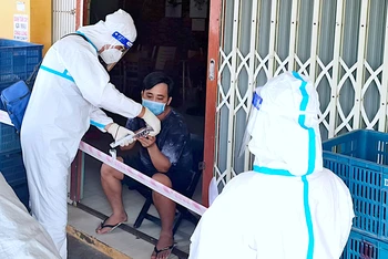 Lực lượng y tế lưu động phường 8 (thành phố Cà Mau) hỗ trợ, thăm khám F0 điều trị tại nhà. 